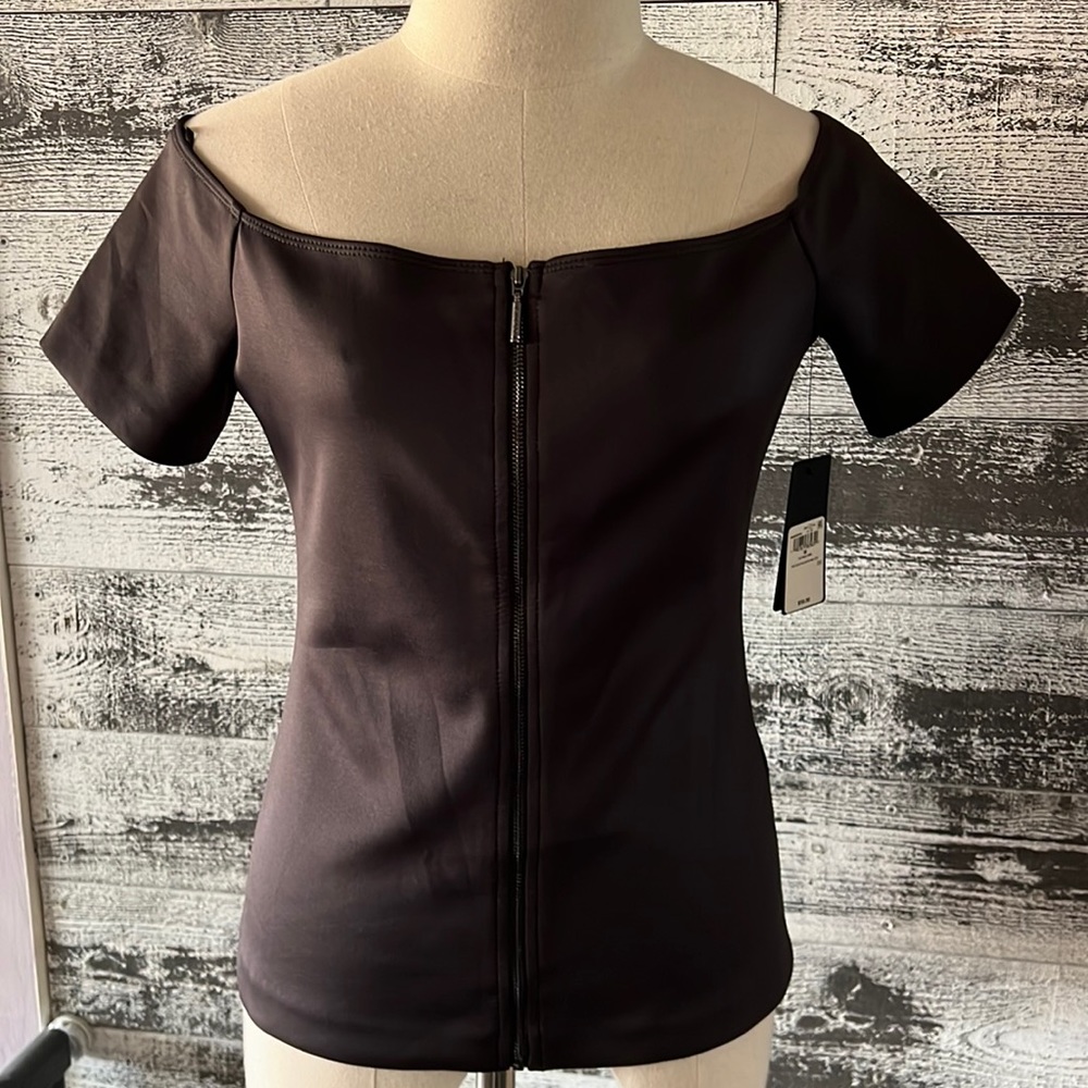 NWT black form fitting blouse with center functional zipper.